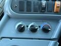 Control panel with knobs for air recirculation heat and temperature adjustment in a 2014 International 4300 truck