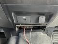 A USB port and a cover for an auxiliary power outlet in the center console of a 2017 Ford F-250 SD