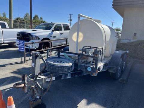 A 2015 Snake Trailer with a large cylindrical tank mounted on it and a spare tire attached at the front