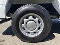 A close-up of a tire and wheel of a 2019 Ford F-150 showing a silver rim with five spokes and a black tire with tread visible