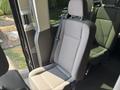 A single gray fabric seat from a 2025 Ford Transit T-350 with a patterned design and seatbelt on the side