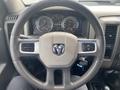 Steering wheel of a 2011 Dodge Ram 5500 with the Ram logo visible and dashboard gauges in the background