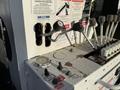 Close-up of control levers and gauges on a 2011 International 7500 featuring various warning labels and a notice sign