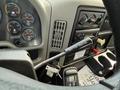 Interior view of a 2011 International 4300 truck showing the dashboard with gauges the gear shifter and controls for air conditioning and heating