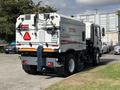 A 2012 Autocar Xpert street cleaning truck with a white body and rear vacuum attachment parked on a driveway