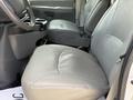 Interior view of a 2008 Ford Econoline showing two gray front seats with a console and cup holders between them