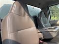 The interior of a 2009 Ford F-550 featuring two leather front seats and a center console