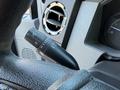 Close-up of the steering column controls in a 2010 Ford F-450 featuring various switches and knobs for vehicle operations