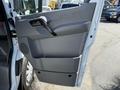 A 2017 Mercedes-Benz Sprinter van door, featuring a gray interior panel with a handle and storage compartment