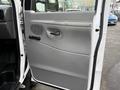 A 2008 Ford Econoline van door featuring a gray panel with a handle a speaker grille and a simple design