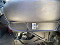 A close-up of the driver's seat of a 2014 International TerraStar showing the armrest and lever for seat adjustment