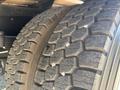 Close-up of a textured tire of a 2004 Ford F-750 showcasing its tread pattern and grooves