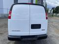 2023 GMC Savana van viewed from the rear with a plain white exterior and no license plate visible