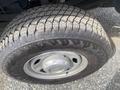 Close-up of a tire from a 2014 Ford F-350 SD displaying a detailed tread pattern and the rim with a Ford logo