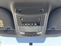 A 2019 Ford F-550 overhead console featuring buttons and light controls with a textured surface and speaker grilles.