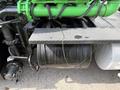 A green engine component and fuel tank on a 1996 Kenworth T800 truck with visible piping and connections