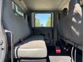 The interior of a 2011 International 4300 truck featuring a spacious bench seat with grey upholstery and seat belts