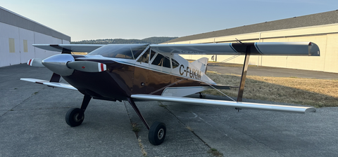 A 1986 Sorrell Hiperbipe SNS-7 amateur-built aircraft with a sleek fuselage and biplane wings positioned on a concrete surface
