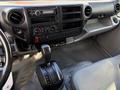 Interior view of a 2014 Hino 195 showing the dashboard with controls and a gear shifter in the foreground