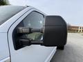Side view mirror of a 2020 Ford F-550 showcasing a black mirror housing and adjustable arm