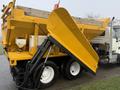 A yellow 2016 International 7400 truck equipped with a large raised dump body and a snow plow attachment on the front