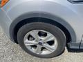 A close-up of a silver 2015 Ford Escape's wheel and tire showcasing the alloy rim and tread pattern