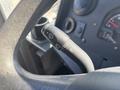 Close-up of a 2012 Ford E-450 steering wheel with a multifunction lever for turn signals and windshield wipers