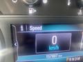 Close-up of a digital speedometer display from a 2018 Buick Encore showing a speed of 0 km/h and a total mileage of 157697 km