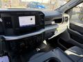 Interior view of a 2024 Ford F-550 showcasing the dashboard controls and infotainment system with air conditioning knobs and digital display