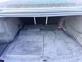 Interior view of the trunk of a 2020 Jaguar XE featuring carpeted floor mats and a spacious, clean area for storage