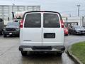 A 2021 Chevrolet Express van is shown from the rear with a white exterior and no visible license plate