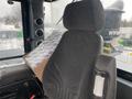 A 2016 Hyundai HL940 construction vehicle seat with a textured fabric covering and a piece of cardboard resting against it