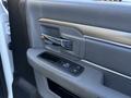 Interior door panel of a 2015 RAM 4500 with a chrome door handle and window control buttons