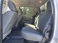 Interior view of a 2014 RAM 5500 crew cab showing gray fabric seats with seat belts and a center console between them