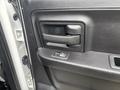 Interior door handle of a 2016 RAM 1500 featuring a black plastic finish and a window control button