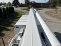 A 2019 Freightliner M2 106 truck with a white extended boom and equipment on the back viewed from above