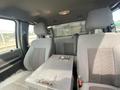 Interior view of a 2014 Ford F-350 SD showing front seats and a center console with a storage compartment