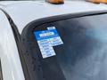 A 2015 Ford F-350 with a certificate of approval sticker on the driver's side window displaying months of the year