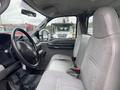 Interior view of a 2005 Ford F-350 SD with gray fabric seats and visible dashboard controls