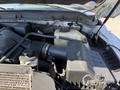 Close-up of the engine compartment of a 2012 Ford F-350 SD showing the air intake and coolant reservoir