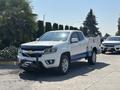 A 2017 Chevrolet Colorado in white with blue accents features a utility bed and front winch in a front three-quarter view