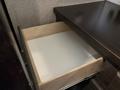 An open drawer from a 2021 Jayco Jay Flight with a wooden frame and empty white bottom