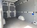 Interior view of a 2025 Mercedes-Benz Sprinter van showcasing empty cargo space with gray walls and a flat floor