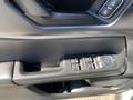 Interior door panel of a 2023 Ford Bronco Sport featuring window controls and a textured black surface