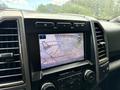 Dashboard view of a 2019 Ford F-150 with a rearview camera display showing guidelines for parking