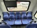 Five blue seats with seat belts in the interior of a 2020 Chevrolet Express van