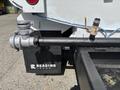 A 2016 Ford F-750 featuring a black Reading Truck box and a metal pipe connected to a valve and fitting