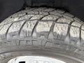 Close-up of a rugged tire on a 2016 RAM 1500 showcasing deep treads and dirt accumulation