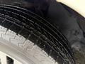 Close-up of a wet tire on a 2018 Toyota 4Runner showcasing the tread pattern and detail of the tire sidewall