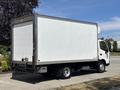 A 2018 Hino 195 truck with a large white box cargo area parked on a street